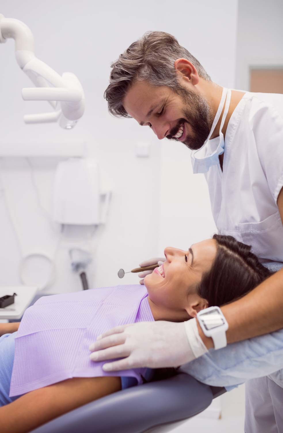 TPD-dentist-smiling-while-examining-patient